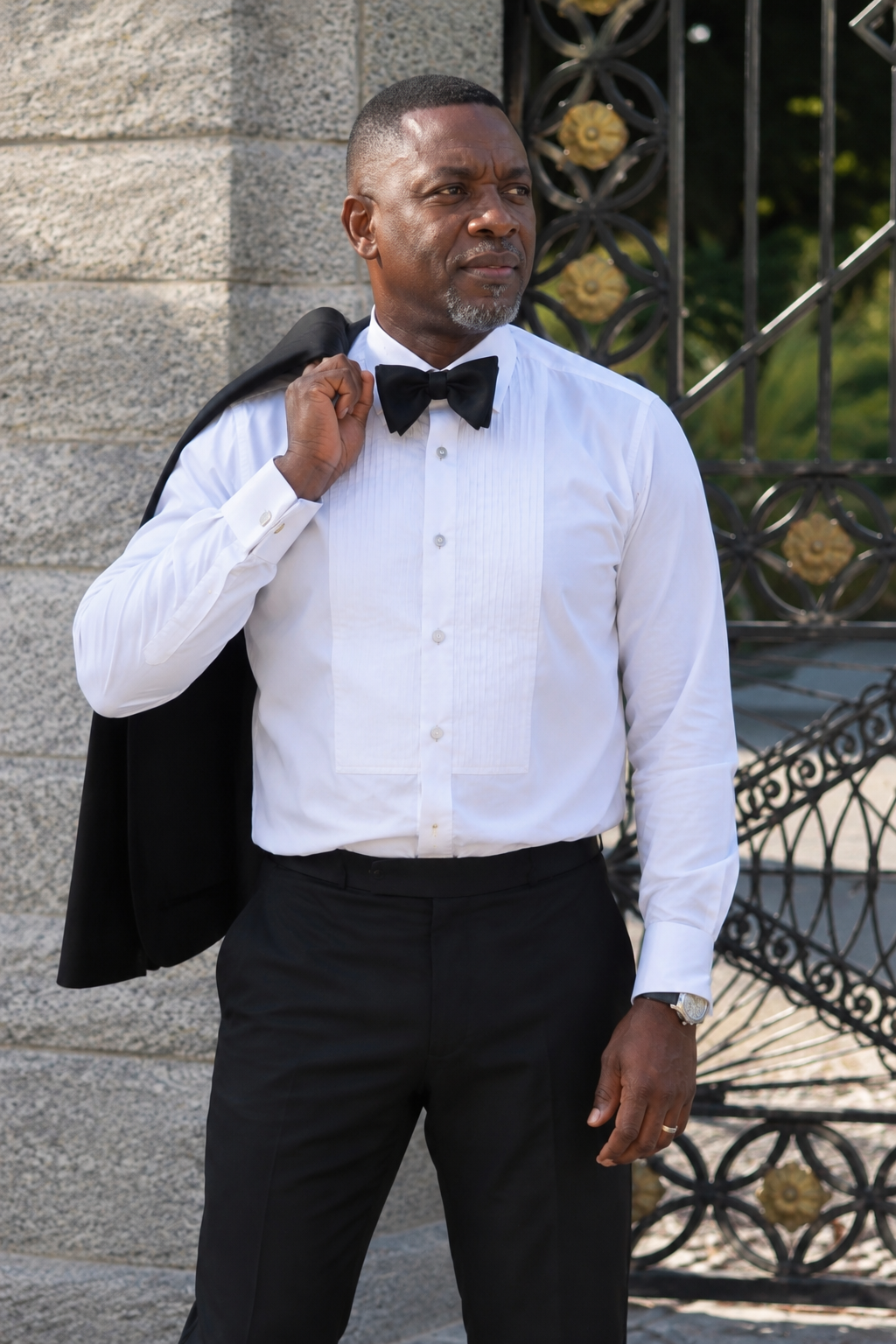 Black tie tuxedo shirt and jacket over the shoulder